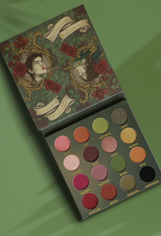 MEET ME IN THE UNDERWORLD PALETTE LOIS COSMETICS, A 16 SHADE PALETTE WITH KHAKI BACKGROUND. SHADES ARE A MIX OF GREENS, KHAKIS, BROWNS, REDS AND MUTED PINKS AND MAUVES. PALETTE ARTWORK DISPLAYS A VINTAGE STYLE OF ORPHEUS AND EURYDICE AND ROSES ON COVER